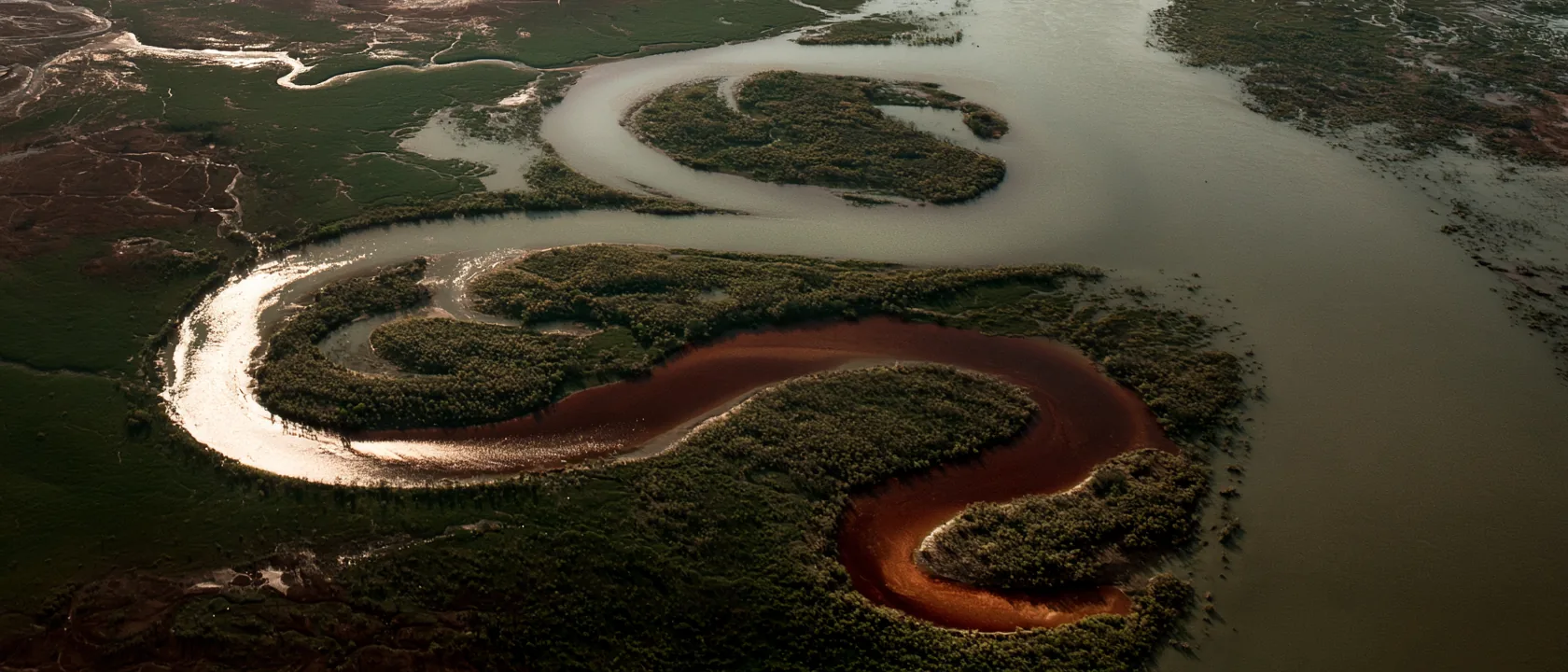 A glowing river winds through the vast, living landscape of Nakãya.