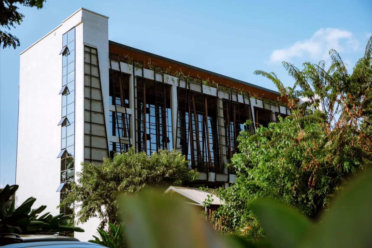Norrsken House Kigali, a white building with tall windows among tropical plants