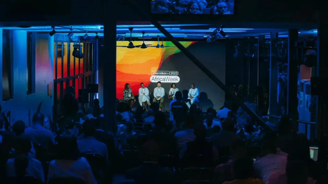 A panel on stage in a blue-lit hall at Norrsken Africa Week.